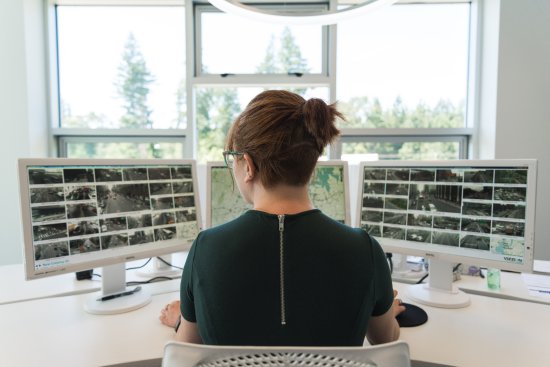 A Vizzion employee examines camera feeds in the Desktop Video Wall.