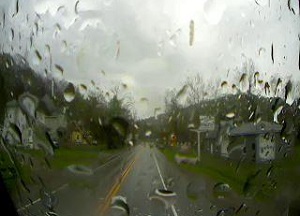An on-vehicle image showing a rainy roadway