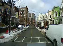 An on-vehicle camera showing snow in an urban area